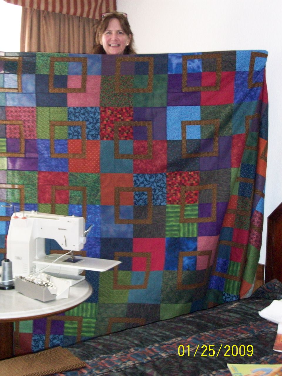 My sister, Laurel with the quilt we pieced for her son, Joe.